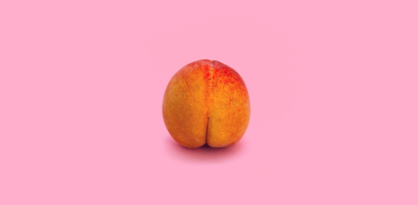 Photo of a peach on a pink background